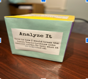 "Analyze it" dice face prompting students to answer based on how the die lands. 